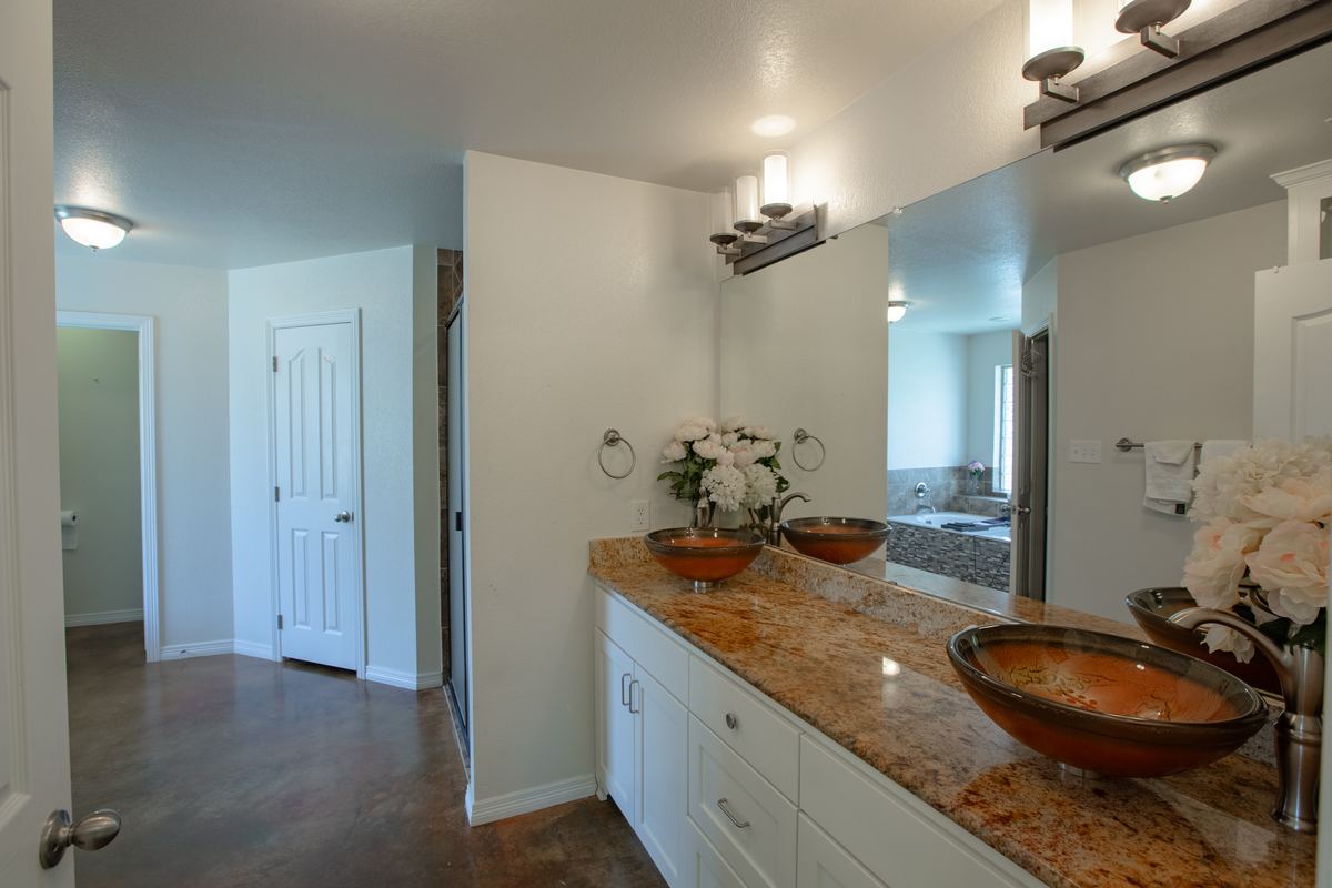 Double vanity with copper vessel sinks and granite counter